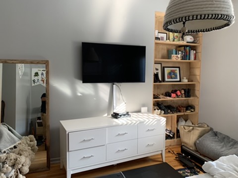 Before — bedroom TV with visible wires