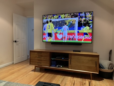 After — large TV mounted + soundbar