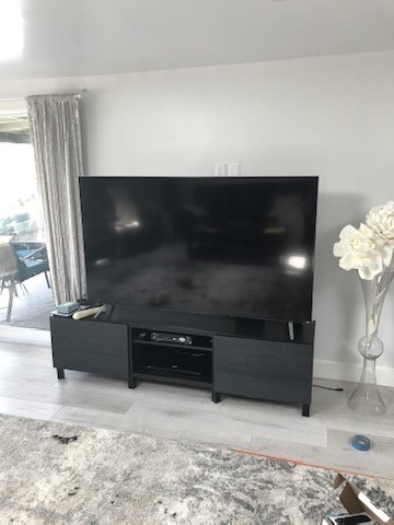 Before — TV on stand with grey floors